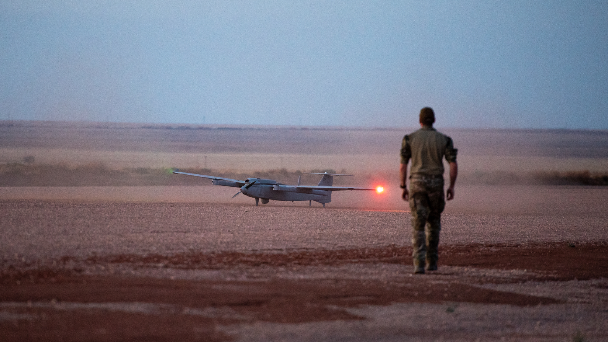UAV at dusk on a desert strip with Aveo DroneV navigation lights lit