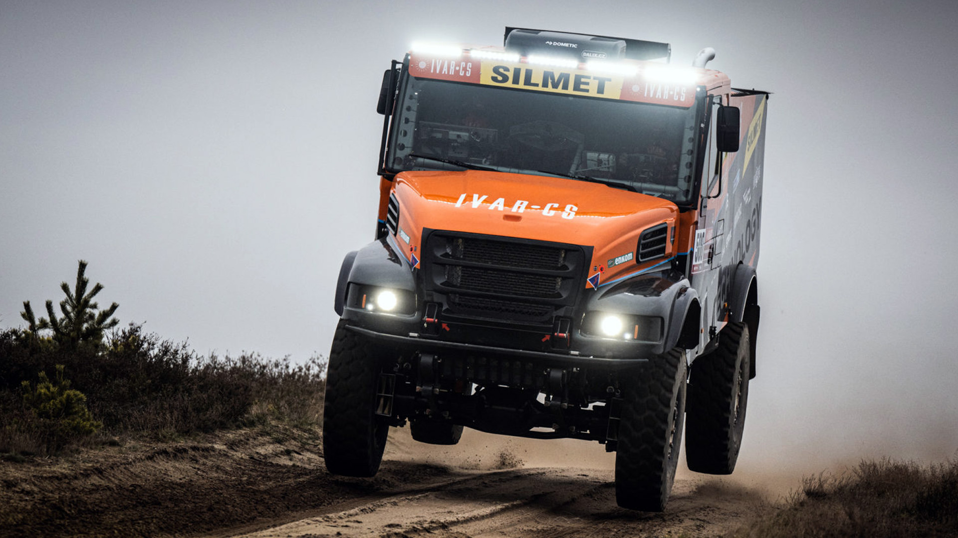 Aveo-lit Prometeon Dakar rally truck airborne on a desert stage