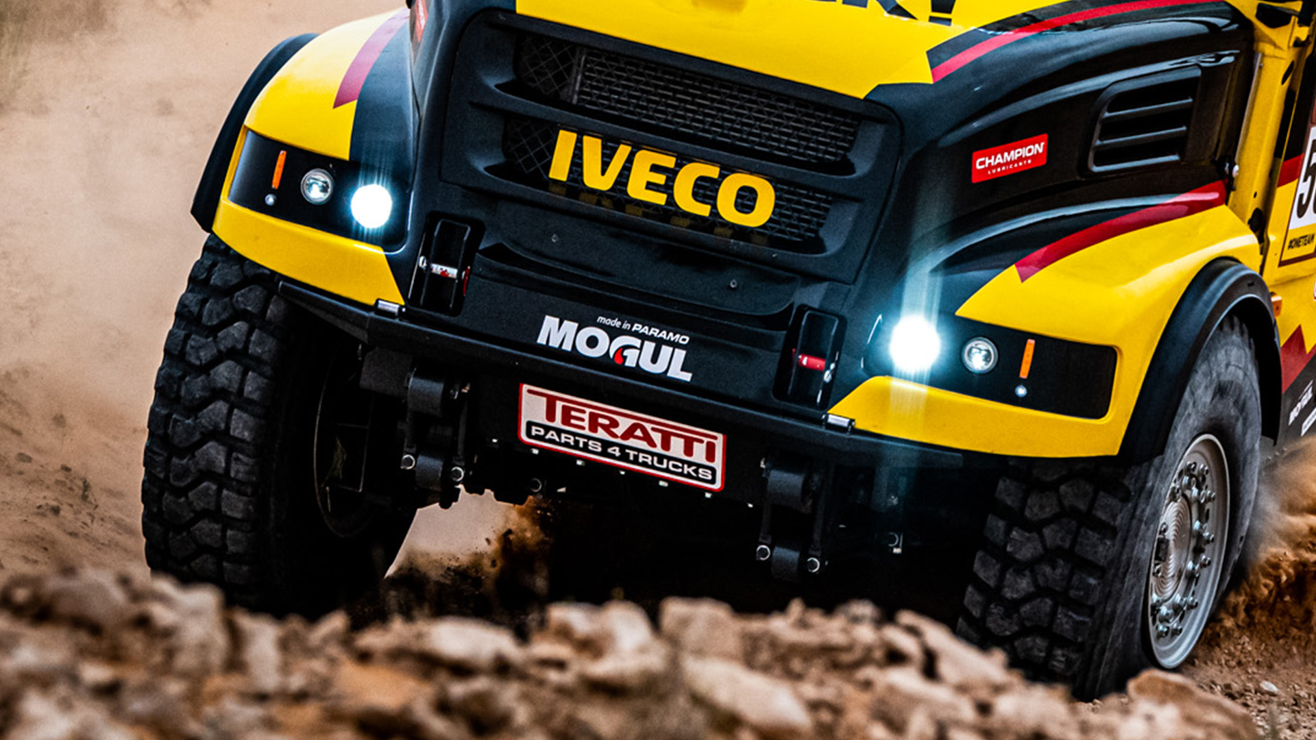Yellow IVECO Dakar rally truck front close-up with Aveo lighting